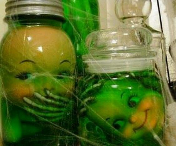 Take old doll parts, add some skeleton parts, fill jar with water, and add green food coloring. Awesome!