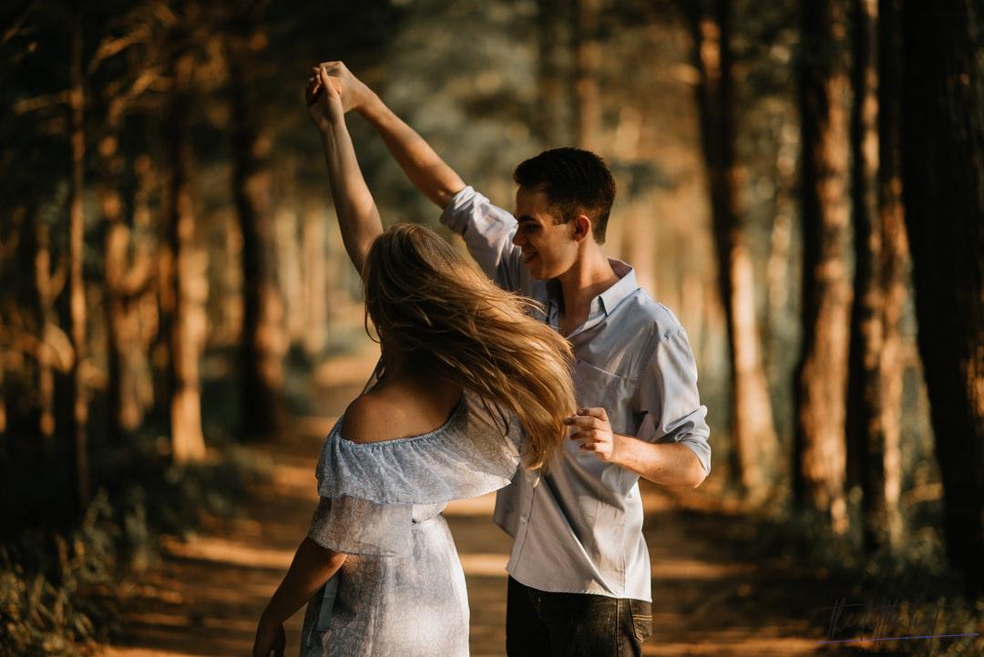 couple of lovers dancing among the trees