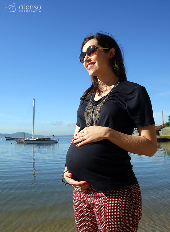 Pregnant woman with sunglasses and necklace