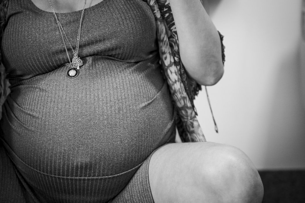 Black and white photo of a pregnant belly close-up.