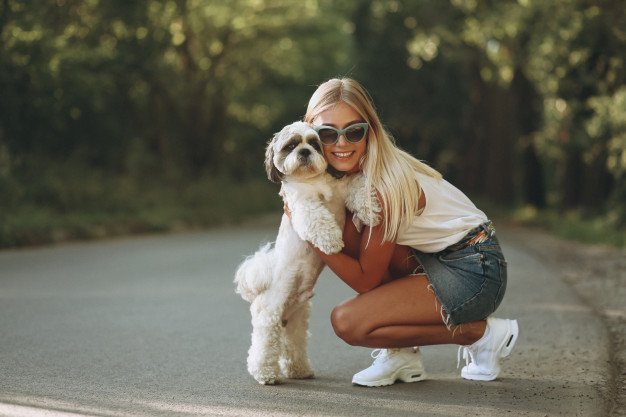 blonde woman on the street with her dog