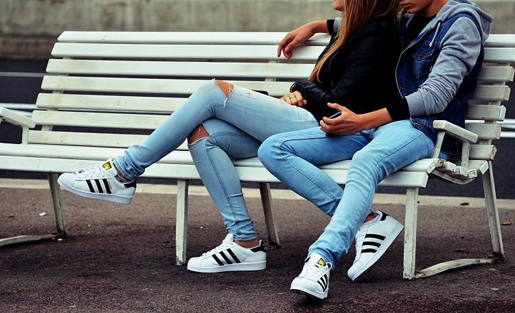 couple sitting on a bench in matching clothes, couple tumblr photo captions