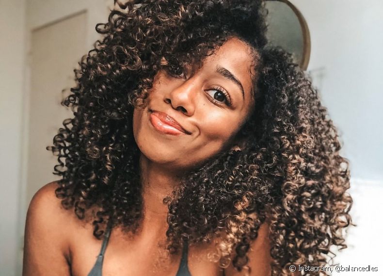 Depending on how it's done, layered haircuts for curly hair can either reduce volume or further enhance the curls' armed look.
