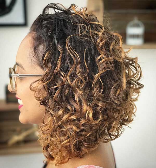 Curly Chanel with coppery blonde locks.  The curls are very simple