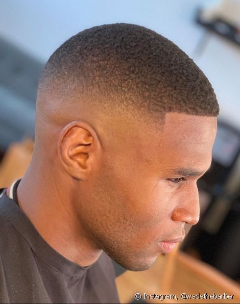 Black male sideways with male buzz cut haircut. 