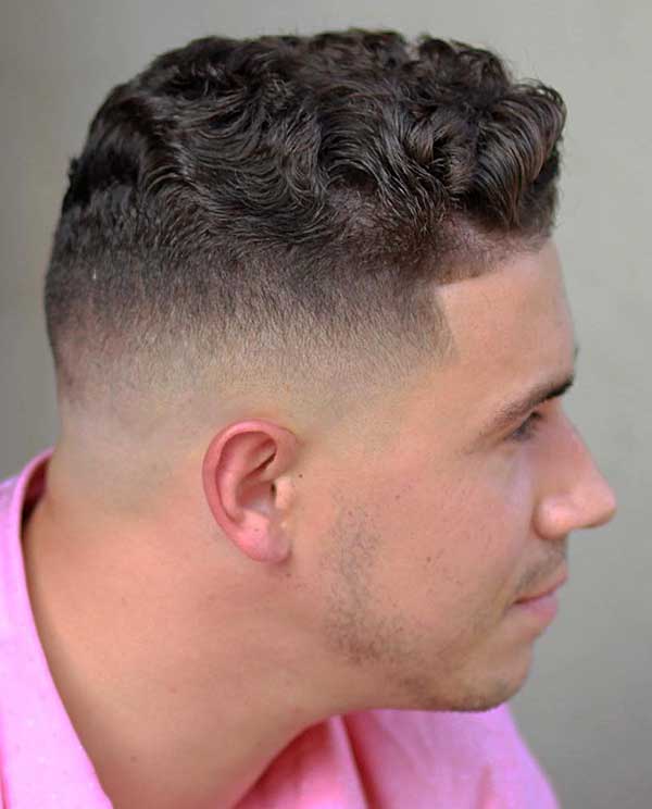 Fade on the sides and top with thick wavy hair
