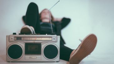 photo of woman listening to music on the radio