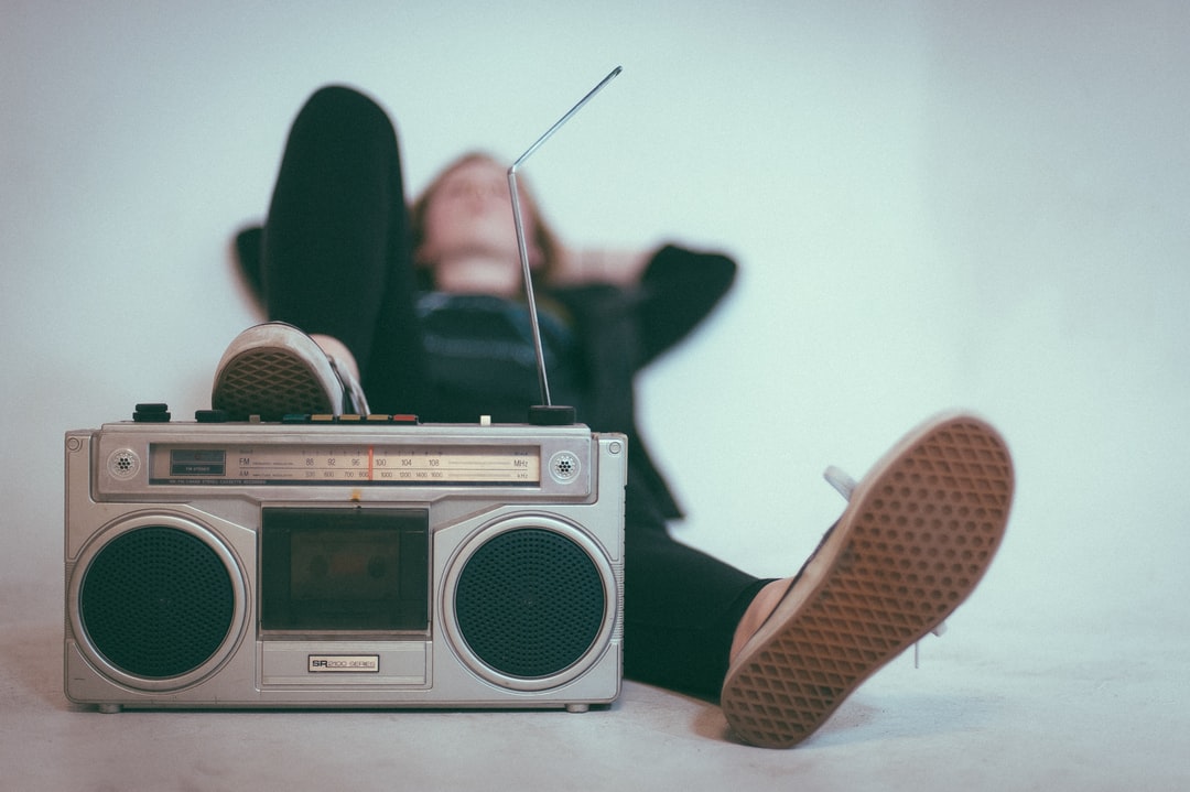 photo of woman listening to music on the radio 