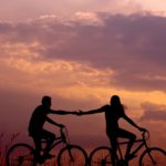 romantic photo of couple riding a bicycle