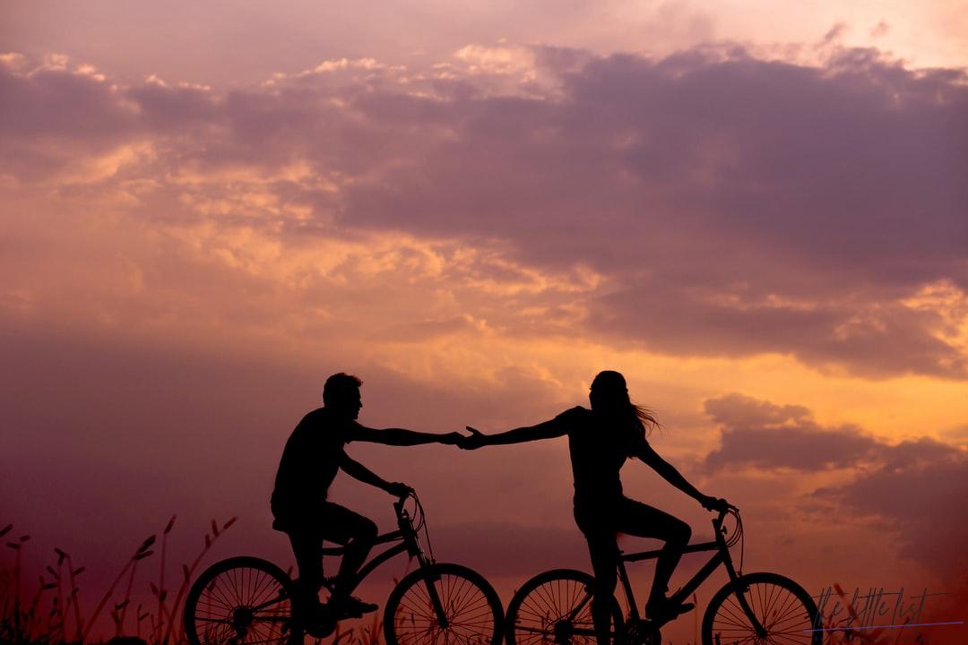 romantic photo of couple riding a bicycle