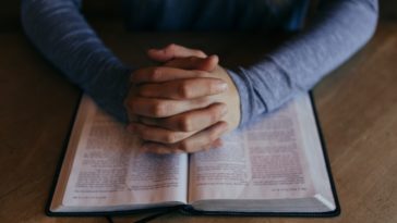 Christian photo praying over the bible