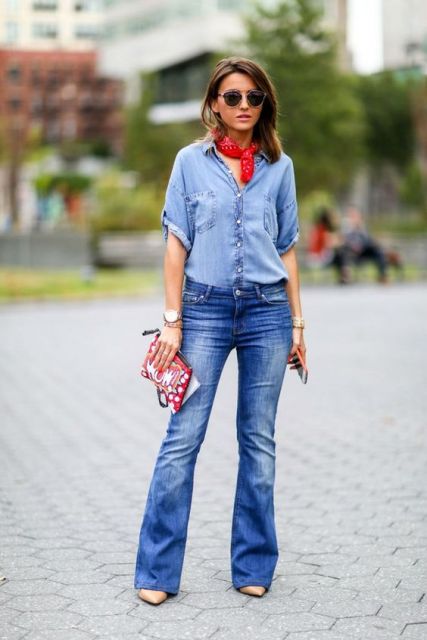 Model wears flared jeans with shirt, heels and red scarf.