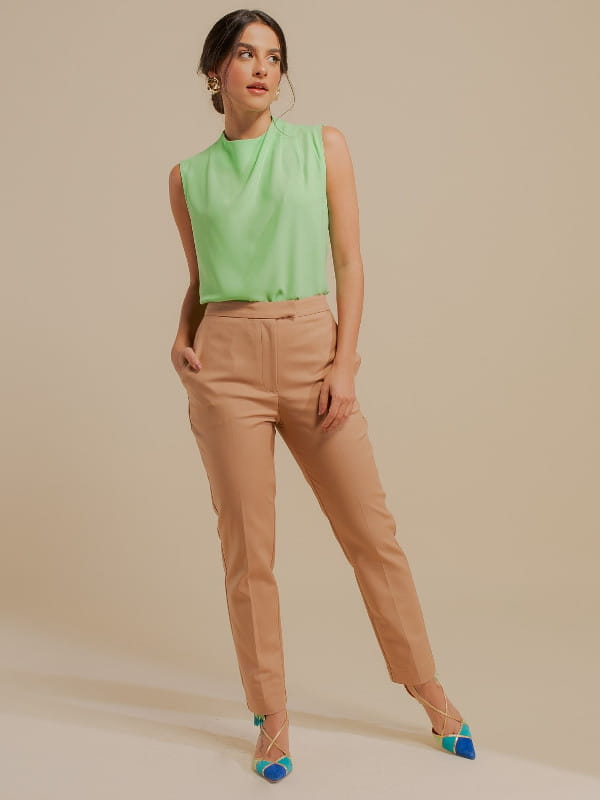 Women's clothes for work: model with tailored beige twill pants.