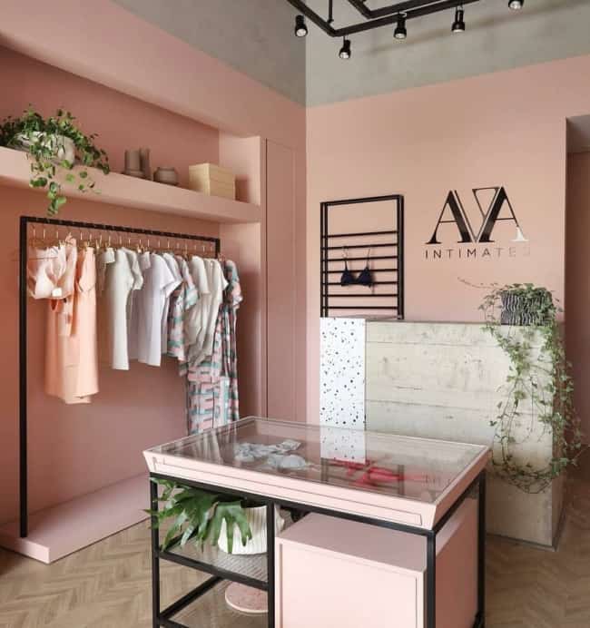 small clothing store decor with pink wall