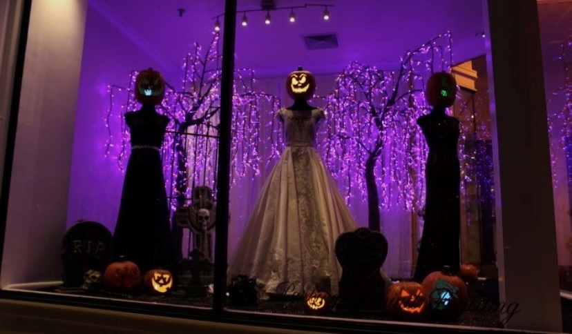 Bridal clothing store window with Halloween decor