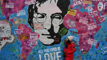 Wall with drawing by John Lennon in Prague and phrases from the Beatles music