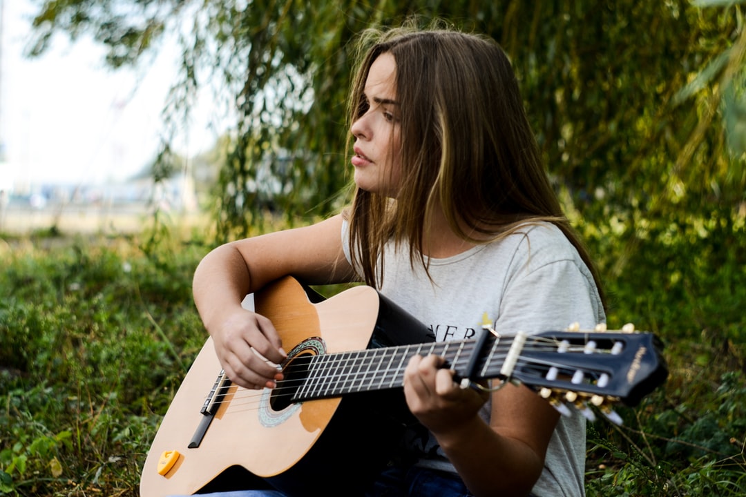 girl playing music on the guitar